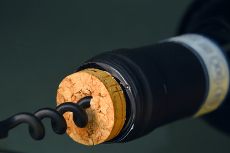 Close up of corkscrew trat uncork a bottle of red wine.の写真素材