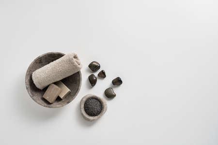 Towel and soaps with relaxing bath salts on a white background, with space for text and graphics.の写真素材