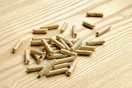 a pile of wood pellets fuel placed on a top of the same wood.の写真素材