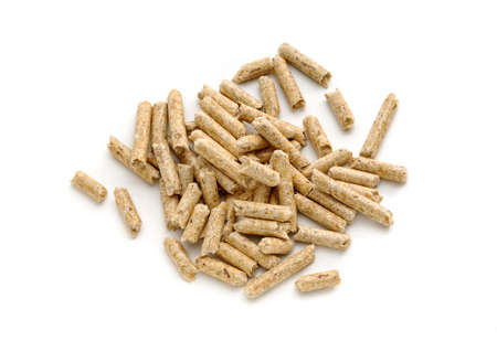 A pile of wood pellets on an isolated white background.の写真素材