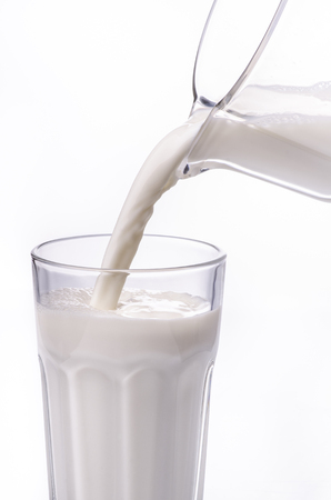 jug with fresh cow's milk is poured into the glassの写真素材