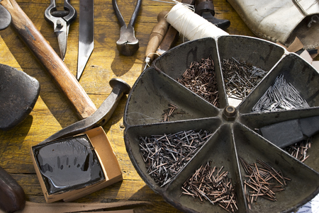 small ancient workshop with tools of the old cobbler's craft