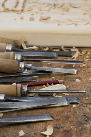 variety of metal chisels to carve wood on the craftsman's bench