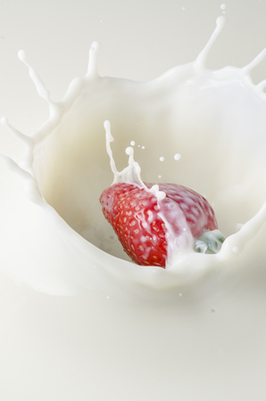 delicious strawberry sinks into the milk with splashes and dropsの写真素材