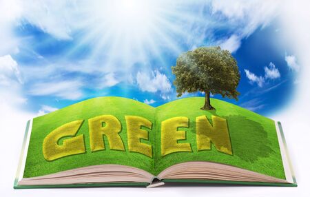 pages of an open book illustrated with a green lawn and an ecological natureの写真素材