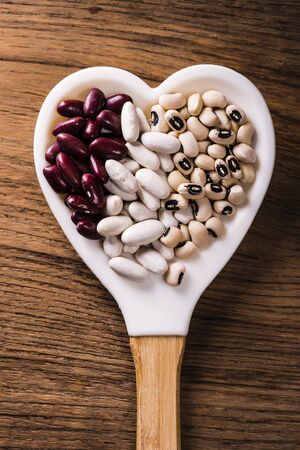 heart-shaped spoon full of dry beans typesの写真素材