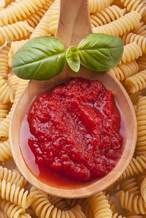 ladle full of homemade tomato sauce to season pastaの写真素材