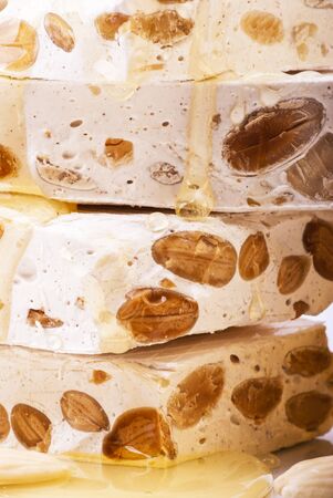 delicious artisan nougat in pieces with honey and almondsの写真素材