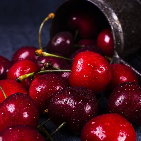 fresh cherries in closeup in a metal cup