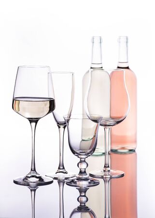 glass of rose wine and some wine glasses of different types in transparencyの写真素材