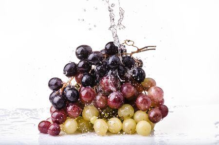bunch of table grapes with splash of waterの写真素材