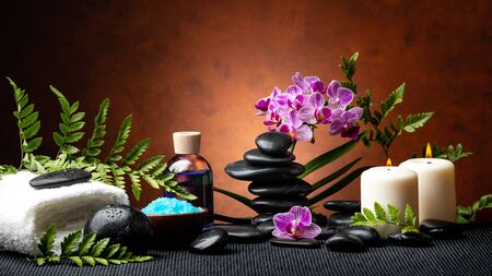 candle light spa treatment set with aromatic salt, perfumed essence, stones and orchid flowers with...