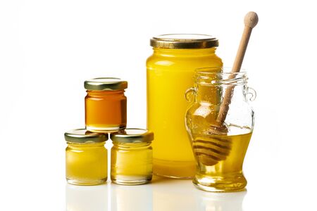 some types of honey in glass jars isolated from the white background