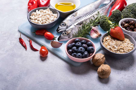 on the textured background, variety of Mediterranean healthy foods based on legumes, fish, vegetables, fruits and grainsの写真素材