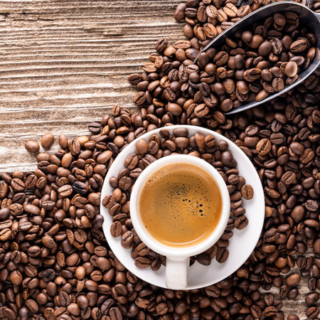 Top view of cup of Italian espresso with roasted coffee beans on rough wooden background. empty spaceの写真素材