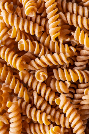 background with italian wholemeal pasta. fusilliの写真素材