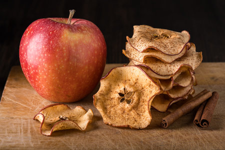 in the foreground homemade dried apple slices flavored with cinnamonの写真素材