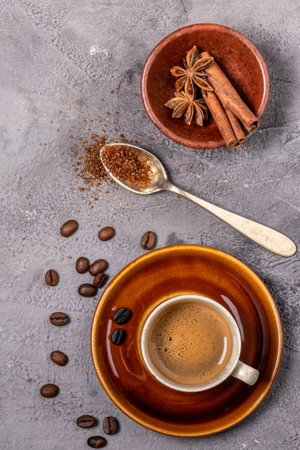 espresso coffee in cup, flavored with cinnamon and star anise, top view on gray textured backgroundの写真素材
