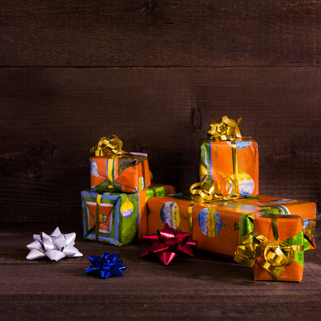 Many Christmas presents on planks backgroundの写真素材