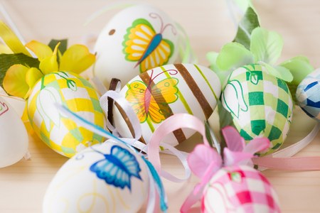 Close up of painted handmade easter eggs on a wooden tableの写真素材