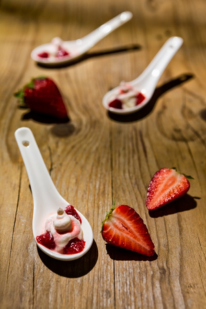 Mascarpone cream and strawberries on wooden backgroundの写真素材