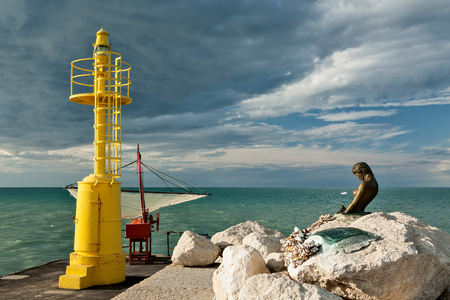 The pier in Senigallia at sunset after a storm.の写真素材