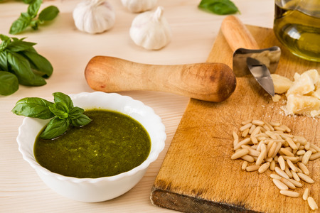 Closeup of pesto genovese with its ingredients over a tableの写真素材