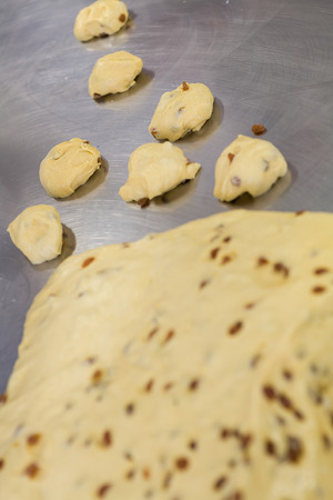 Dough for buns with raisin over a worktableの写真素材