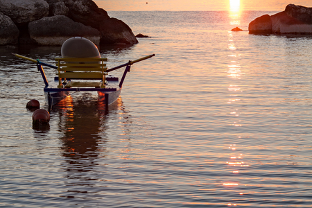 Pedalo moored in the sea at sunrise on a clear and colorful summer morningの写真素材