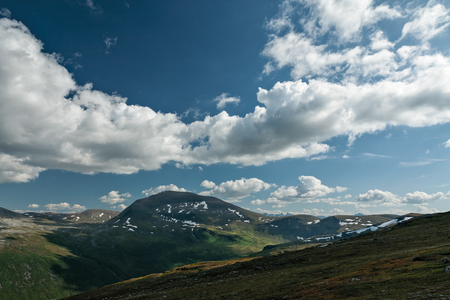 Panoramic mountains view with blue sky and white clouds in Norwayの写真素材