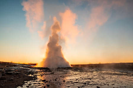 Eruption of the Geysir in Iceland during the sunriseの写真素材