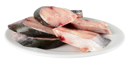 Fresh raw fish on a white plate.の写真素材