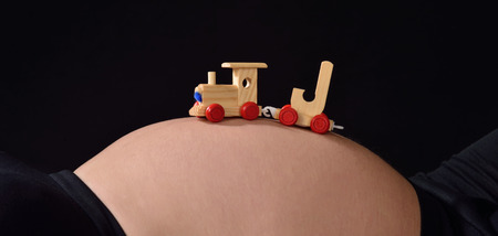 Woman with letter j train on her abdomenの写真素材