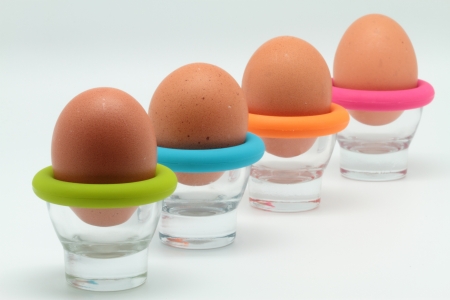 some brown eggs in egg cupsの写真素材