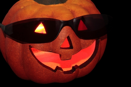 typical halloween pumpkin with sunglasses on black background
の写真素材