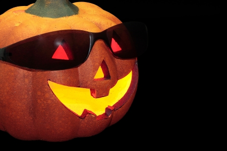 typical halloween pumpkin with sunglasses on black background
の写真素材