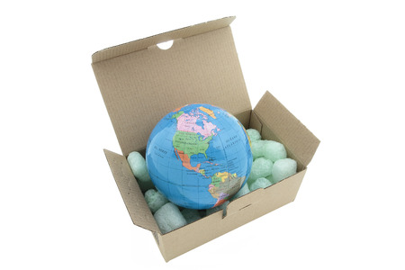 terrestrial globe on a carton box isolated on white backgroundの写真素材