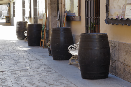 some wooden wine barrels decorating a facade on the streetの写真素材