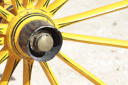 detail of an antique yelow cart wheelの写真素材