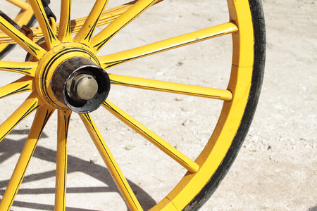 detail of an antique yelow cart wheelの写真素材