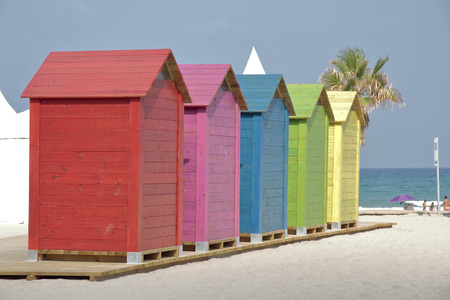 row of colorful changing cabins on the beachの写真素材