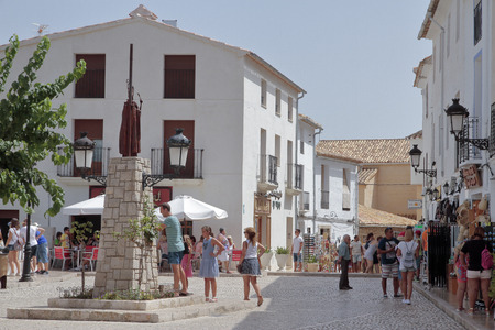 GUADALEST, ALICANTE, SPAIN - AUGUST 28:Tourists visiting the town hall square in El Castell de Guadalest. Picture taken on August 28, 2016 in El castell de guadalest, Alicante, Spainのeditorial素材