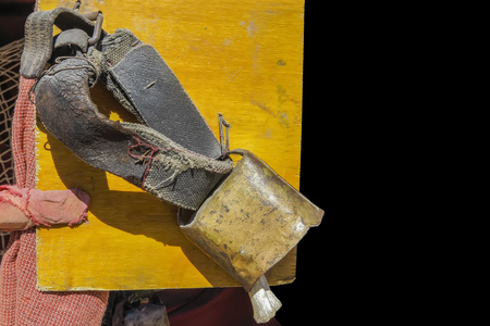 foreground of a cowbell with aged leather beltの写真素材