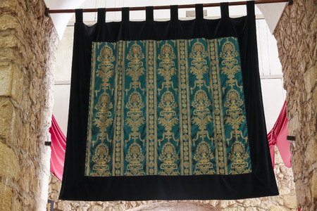 tapestry with embroidered motifs in green and goldの写真素材