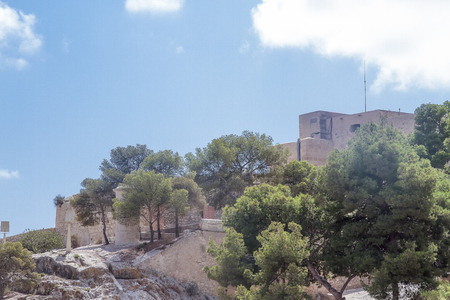 trees and buildings in Santa Barbara castle, alicante, spainの写真素材