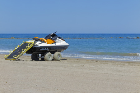 horizontal view of a beach scene in a sunny day with a rescue jet ski in the shoreの写真素材