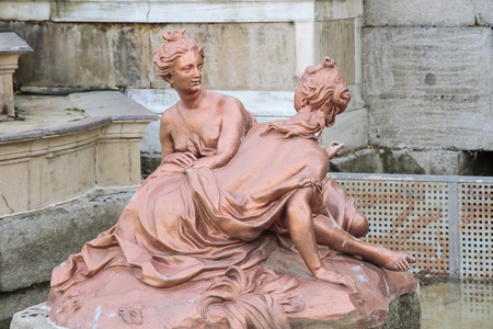 painted lead sculpture of two maids in the fountain the baths of diana in the gardens of royal palace of la granja de san ildefonsoの写真素材