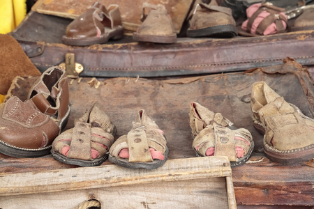 stand with old leather shoes and sandals handmade in a traditional wayの写真素材