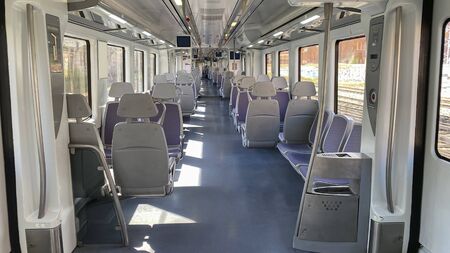horizontal view of a completely empty wagon of a spanish commuter train on a day of emergency due to...