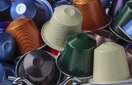 horizontal view of some colored coffee espresso capsules piled up